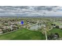 Aerial view showing the property's proximity to a park with pond and the city skyline in the distance at 6735 W 2Nd Ave, Lakewood, CO 80226