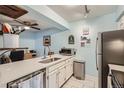 Kitchen featuring white countertops, stainless steel appliances, and tile flooring at 3141 S Tamarac Dr # 110G, Denver, CO 80231