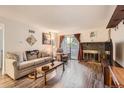 Living room with fireplace, sliding glass doors, and hardwood floors at 3141 S Tamarac Dr # 110G, Denver, CO 80231