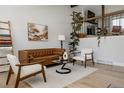 Bright living room with modern decor, hardwood floors, and large windows at 8559 W 75Th Pl, Arvada, CO 80005