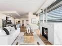 Cozy living room with a marble fireplace and large windows providing natural light and city views at 2001 Lincoln St # 3121, Denver, CO 80202