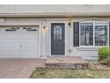 Front door and garage of a two-story home featuring a brick driveway at 20000 E Mitchell Pl # 39, Denver, CO 80249