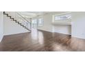 Bright living room with wood floors, white walls, staircase, and natural light at 20000 E Mitchell Pl # 39, Denver, CO 80249