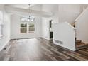 Bright living room features soaring ceilings, large windows, and stunning hardwood floors at 17040 Numa Pl, Parker, CO 80134