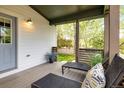 Spacious covered porch with lounge chairs, ideal for enjoying the outdoors in comfort and style at 2552 Stonewall Ln, Lafayette, CO 80026