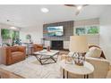 Inviting living room featuring a modern fireplace, comfortable seating, and large windows showcasing a beautiful view at 5405 S Lowell Blvd, Littleton, CO 80123