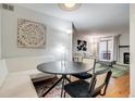 Dining area with a built-in bench, modern lighting, and views into the living room at 4671 S Decatur St # 232, Englewood, CO 80110
