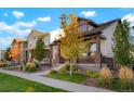 Street view showcasing well-maintained homes with manicured lawns and sidewalks at 20968 E 60Th Pl, Aurora, CO 80019