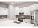 Well-equipped kitchen featuring stainless steel appliances, quartz countertops, and tiled backsplash at 20968 E 60Th Pl, Aurora, CO 80019