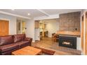 Spacious living room with hardwood floors, fireplace, and a peek into the adjacent kitchen at 805 Columbine Rd # 105, Breckenridge, CO 80424