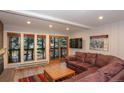 Bright living area features large windows, sliding doors, leather sofa, and a cozy fireplace at 805 Columbine Rd # 105, Breckenridge, CO 80424