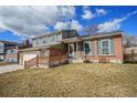 Charming two-story home with brick accents, blue shutters, landscaped lawn, and driveway at 11073 Newland St, Westminster, CO 80020