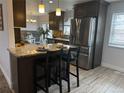 Modern kitchen with granite countertops, stainless steel appliances, and a breakfast bar at 11073 Newland St, Westminster, CO 80020