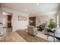 Spacious living room with tiled flooring, natural light, and comfortable seating at 11073 Newland St, Westminster, CO 80020