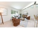 Inviting living room featuring vaulted ceilings, modern decor, and abundant natural light at 7453 E Jefferson Dr, Denver, CO 80237