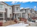 Row of townhomes showcasing similar design and landscaping at 17217 E Exposition Dr, Aurora, CO 80017