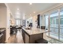 Open-concept kitchen with granite island, stainless appliances, and sliding glass doors to the patio at 5332 13Th St, Frederick, CO 80504