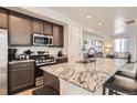 Stylish kitchen featuring granite countertops, stainless steel appliances and island seating at 5332 13Th St, Frederick, CO 80504
