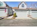 Beautiful home with a gray exterior, two-car garage and sidewalk leading to a welcoming front entrance at 5960 S Jellison St # B, Littleton, CO 80123