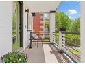 Cozy front porch with seating area, black metal railings, and view of the landscaped front yard at 1845 W 39Th Ave, Denver, CO 80211