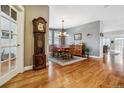 Formal dining room featuring hardwood floors, a classic chandelier, and a traditional wooden dining set at 25015 E Park Crescent Dr, Aurora, CO 80016