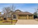 Well-maintained home with stone accents and a three-car garage, offering curb appeal and functionality at 25015 E Park Crescent Dr, Aurora, CO 80016