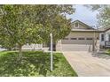 Charming home featuring a two-car garage, well-maintained lawn, and mature trees at 17059 Motsenbocker Way, Parker, CO 80134