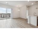 Bright living space with luxury vinyl plank flooring and a sliding glass door with balcony access at 487 Interlocken Blvd # 409, Broomfield, CO 80021