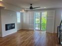 Bright living room with hardwood floors, modern fireplace, and sliding glass doors to balcony at 3404 W 18Th Ave, Denver, CO 80204