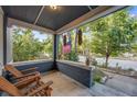 Inviting front porch featuring comfortable seating, potted plants, and classic brick accents at 249 S Lincoln St, Denver, CO 80209