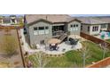 Sprawling backyard featuring a concrete patio with dual seating areas, complemented by an expansive lawn at 11168 Sweet Cicely Dr, Parker, CO 80134