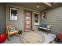 Inviting front porch offers a cozy seating area with a rocking chair, bench, and charming decor at 11168 Sweet Cicely Dr, Parker, CO 80134