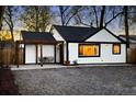 Charming exterior of a white home with black trim, pergola, and a daylight sky at 1755 Ingalls St, Lakewood, CO 80214