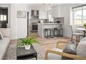 Open living space with modern kitchen, dining area, and comfortable seating arrangement at 1755 Ingalls St, Lakewood, CO 80214