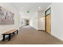 Hallway with carpet and access to condo units, with an elevator visible at the end of the hall at 277 N Broadway # 409, Denver, CO 80203