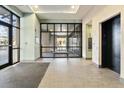 Modern lobby with wood tiled floors, glass entry and elevator access to upper floors at 277 N Broadway # 409, Denver, CO 80203