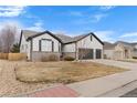 Charming home with attractive architectural details and a well-manicured front yard at 17161 E Dewberry Dr, Parker, CO 80134