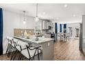 Charming kitchen featuring an island, pendant lighting, and stainless appliances at 5202 Reed St, Arvada, CO 80002