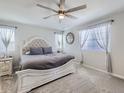 Comfortable bedroom featuring plush carpet, a ceiling fan, and neutral tones, creating a serene atmosphere at 5995 Fencerow Pl, Brighton, CO 80601