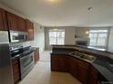 Modern kitchen with stainless steel appliances, granite counters, and a breakfast bar at 17346 Nature Walk Trail Trl # 201, Parker, CO 80134
