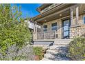 Modern home exterior with stone accents and a welcoming front porch at 21541 E 60 Th Ave, Aurora, CO 80019