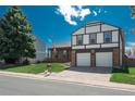 Inviting two-story home with a well-kept lawn and a two-car garage, situated in a peaceful neighborhood at 15930 E Ford Pl, Aurora, CO 80017
