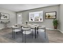 Bright dining room featuring a table with chairs and large bay window at 6087 W 61St Pl, Arvada, CO 80003