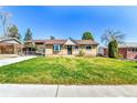Charming brick home with a well-maintained lawn and covered carport at 6087 W 61St Pl, Arvada, CO 80003