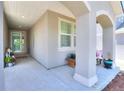 Inviting front porch with decorative pillars, plants, and a view of the front door at 20194 Robins Dr, Denver, CO 80249