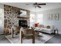 Stylish living room with a stone fireplace, comfortable seating, and an open, airy ambiance at 12631 W Dakota Dr, Lakewood, CO 80228