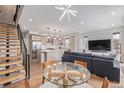Open-concept living room featuring modern decor, hardwood floors, and staircase at 2350 Tremont Pl # 13, Denver, CO 80205