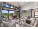 This living room boasts large windows with mountain views, plush seating, and stylish décor for relaxation and enjoyment at 60 Barton Ridge Dr, Breckenridge, CO 80424