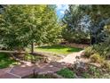 Beautiful backyard with stone pathways, lush greenery, and a tranquil garden at 7346 S Platte Canyon Dr, Littleton, CO 80128