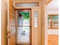 Welcoming entryway featuring a storm door and views to the outside at 9614 W Powers Cir, Littleton, CO 80123